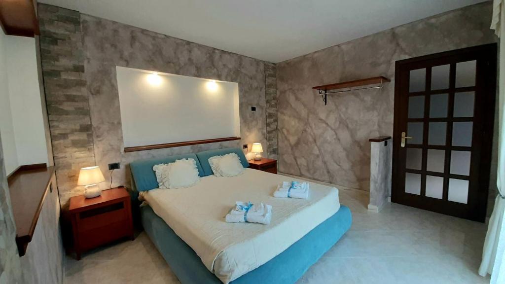 a bedroom with a bed with blue pillows on it at Sardinia B&B house in Olbia