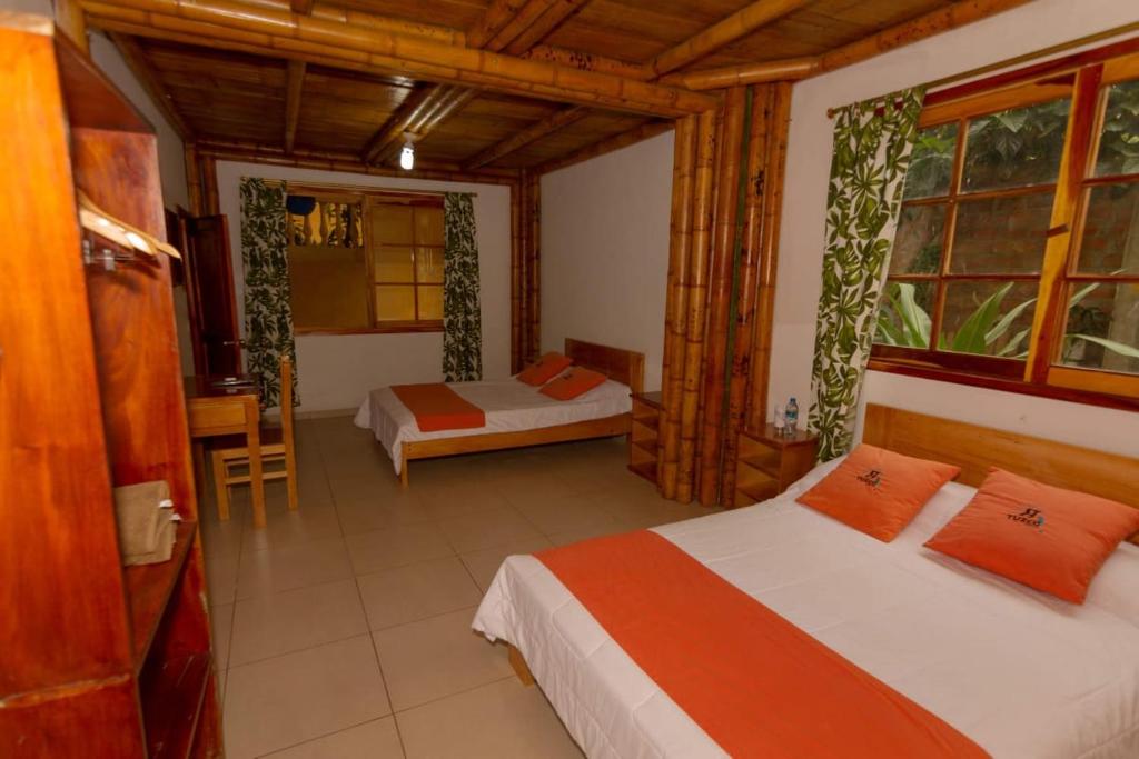 Postel nebo postele na pokoji v ubytování Tuzco Lodge
