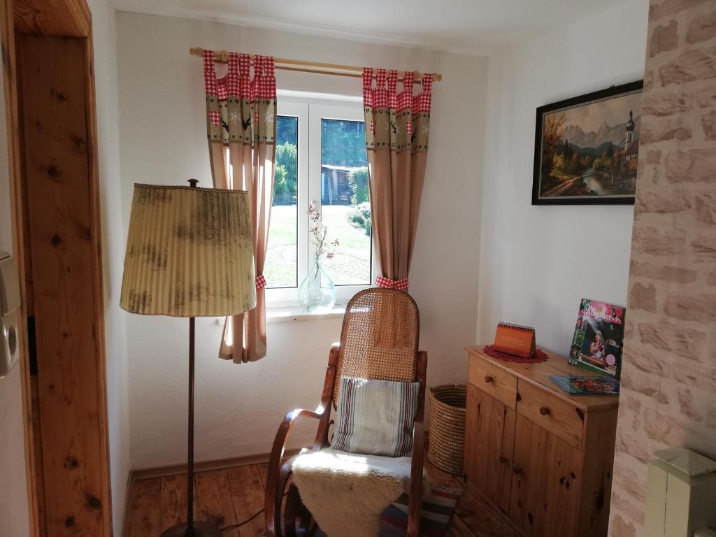 a living room with a chair and a window at Ferienhaus Anni in Rot an der Rot