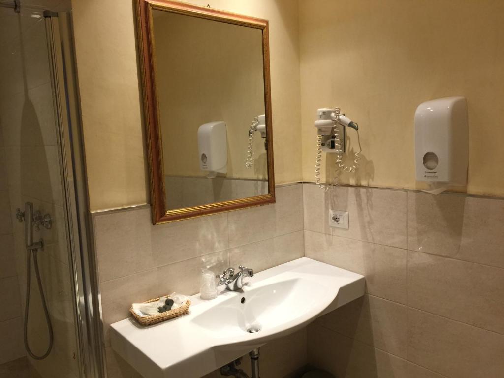a bathroom with a sink and a mirror at Hotel Le Due Fontane in Florence