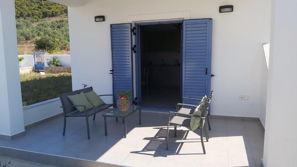 a patio with two chairs and a table at Marko's Cosy Apartment in Megalochori