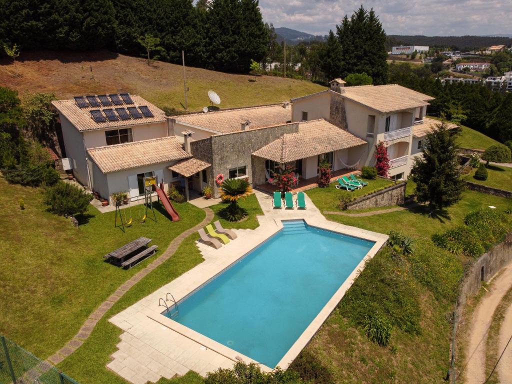 an aerial view of a house with a swimming pool at Quinta do Souto in Sever do Vouga