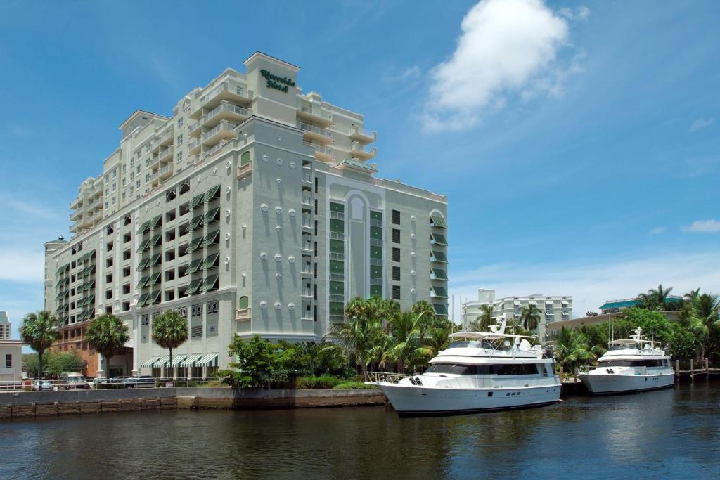 two boats in the water in front of a building at Riverside Hotel in Fort Lauderdale