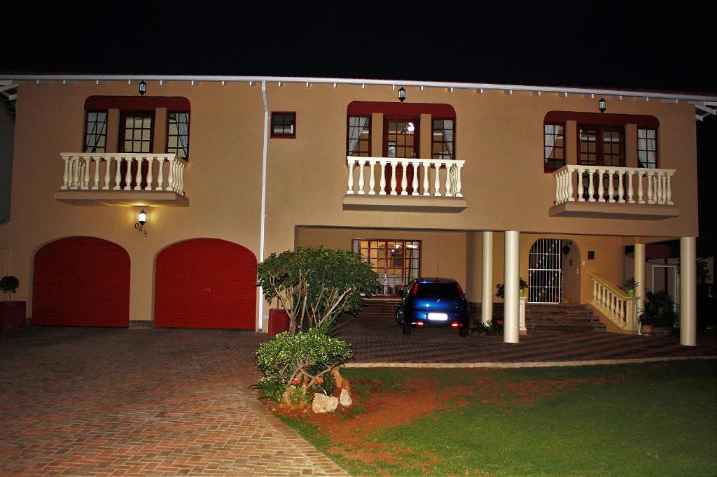 a car parked in front of a house at night at Villa Stella Guest House in Edenvale
