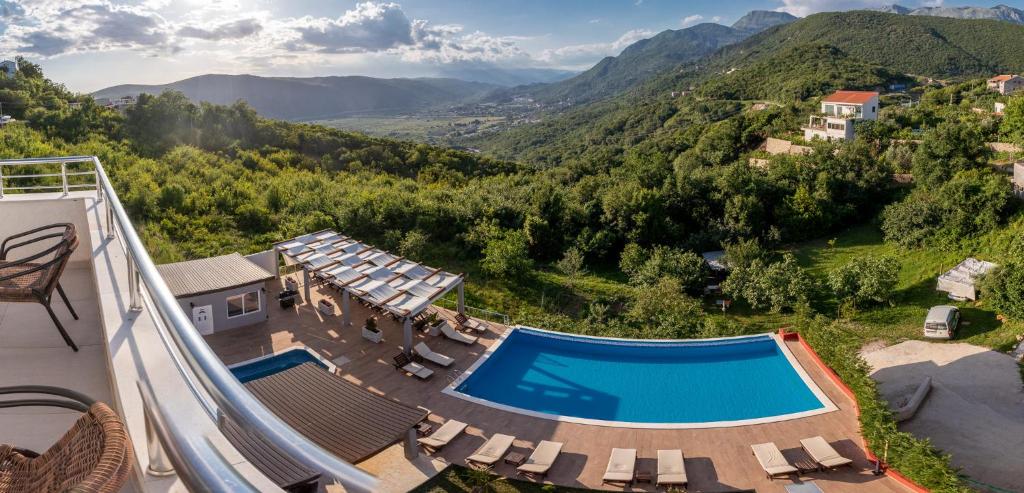 an aerial view of a resort with a swimming pool and mountains at Resort Bevilacqua in Budva