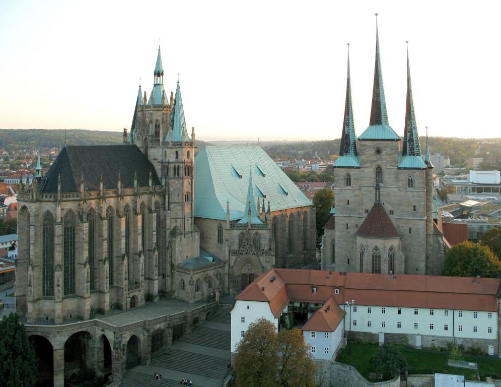 an old cathedral with a city in the background at Privatzimmer in Erfurt