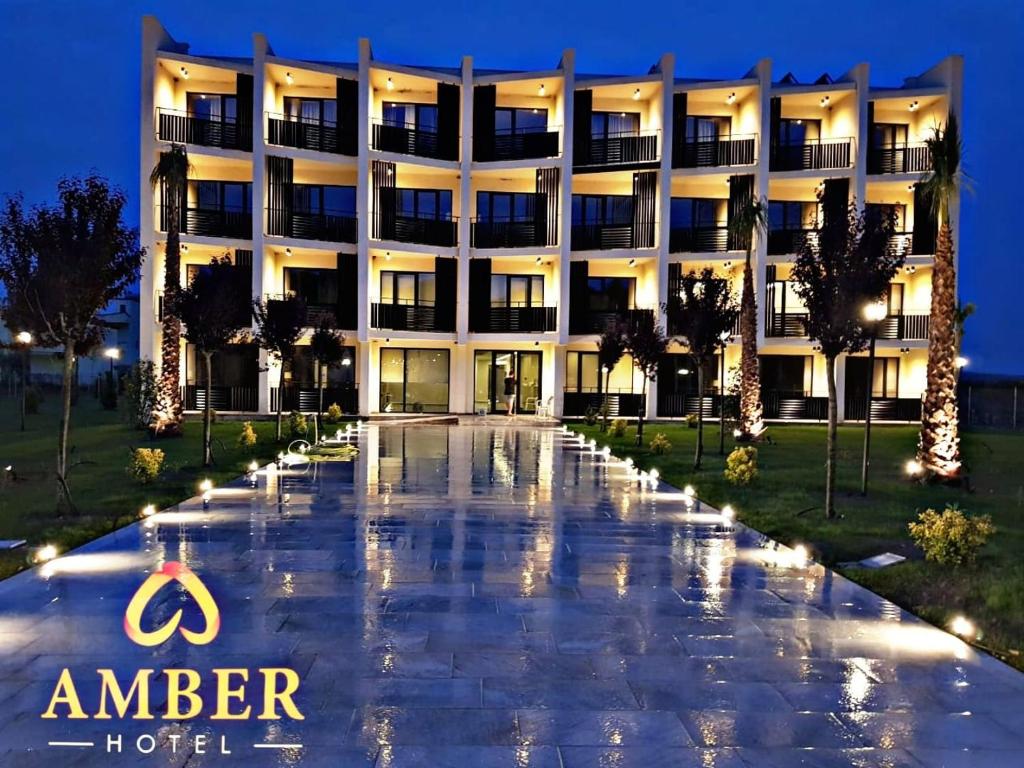 an exterior view of the hotel at night at Amber Hotel Albania in Spille