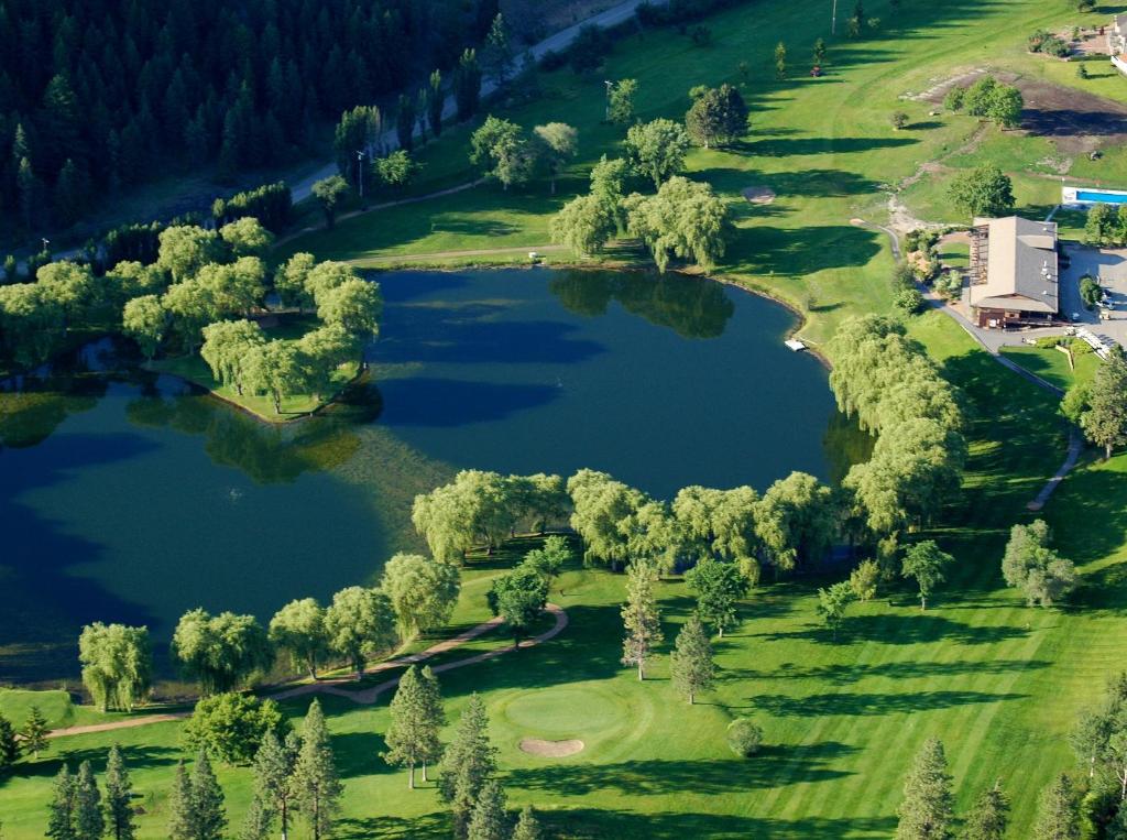 an overhead view of a golf course with two lakes at St. Andrews By The Lake in Kaleden
