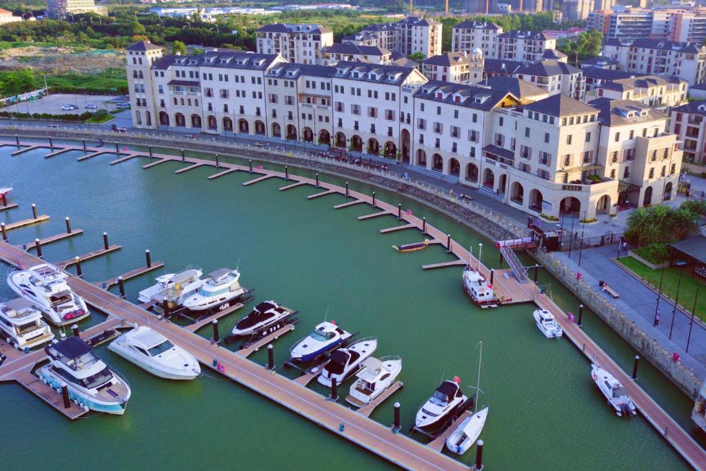 a bridge over a river with boats in a harbor at Guangzhou Nansha Stone Inn in Guangzhou