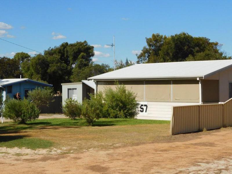 a white building with the number on it at Cottage 57 - Topspot Cottages in Jurien Bay
