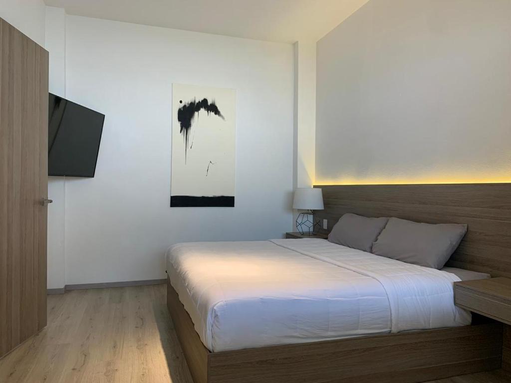 Postel nebo postele na pokoji v ubytování Hotel Blanco Pachuca