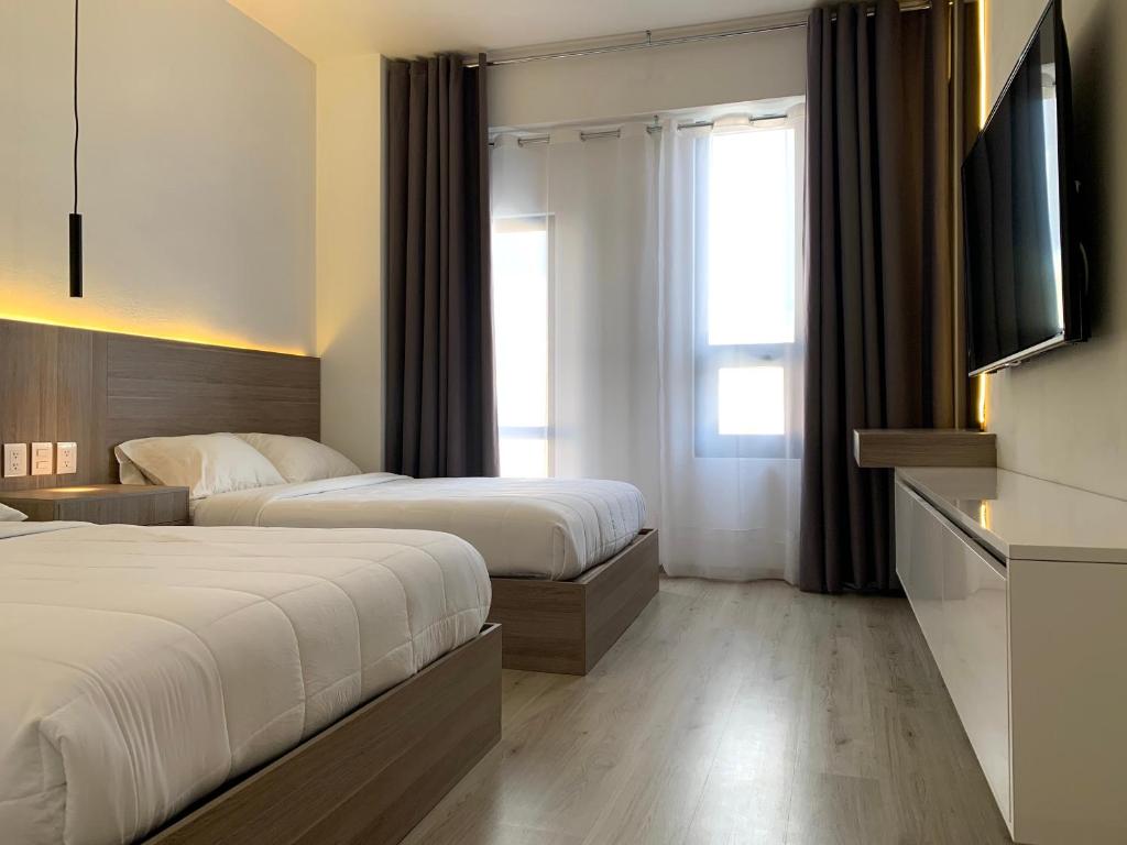 Postel nebo postele na pokoji v ubytování Hotel Blanco Pachuca