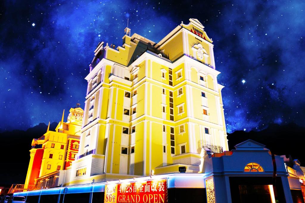 a large yellow building with a clock tower at i RESORT ARTIA Sensual Gifu (Adult Only) in Ginan