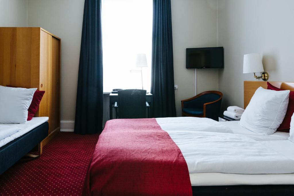Postel nebo postele na pokoji v ubytování City Hotel Nebo