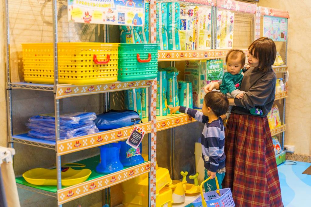 a woman and a child playing in a toy store at Hotel Ocean (Kokusai-Dori) in Naha