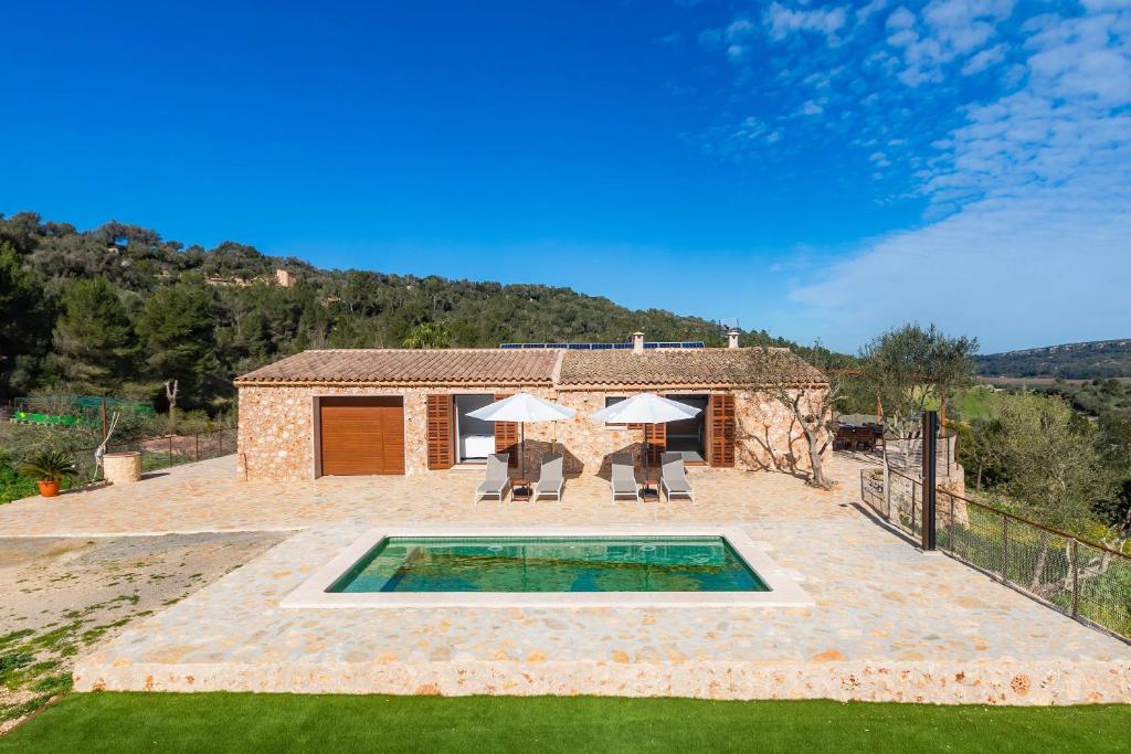 an external view of a villa with a swimming pool at Can Jaume in Manacor