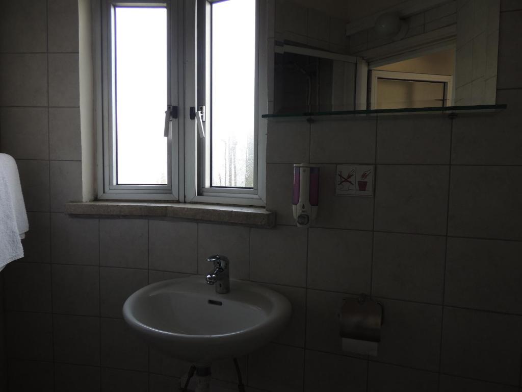a bathroom with a sink and a window at Delphi Hotel in Nicosia