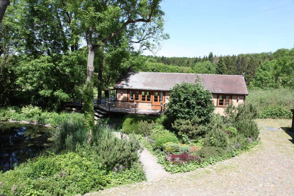 a house in the middle of a garden at Chalet Forsthof Everstorf in Grevesmühlen