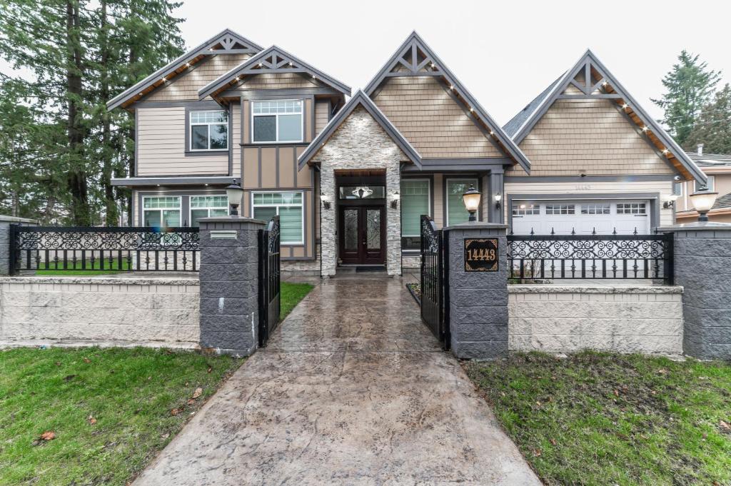 a house with two gates in front of it at Michael's Lodge in Surrey