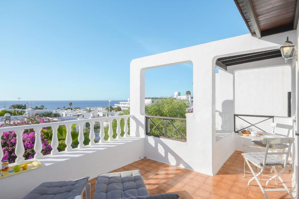 a balcony with a view of the ocean at La Lujancita in Puerto del Carmen