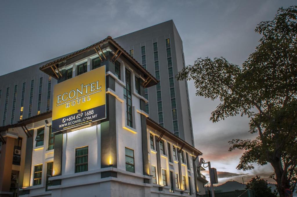 a building with a sign on the side of it at Econtel Queensbay in Bayan Lepas