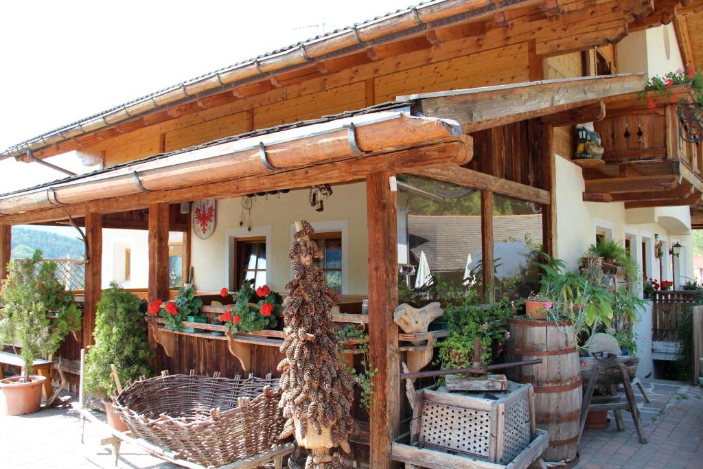 a wooden pergola with a bunch of plants in it at Verleierhof in Castelrotto