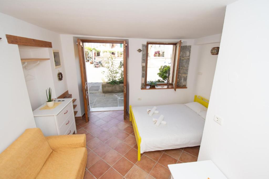 a small room with a bed and a couch at Studio May in Piran