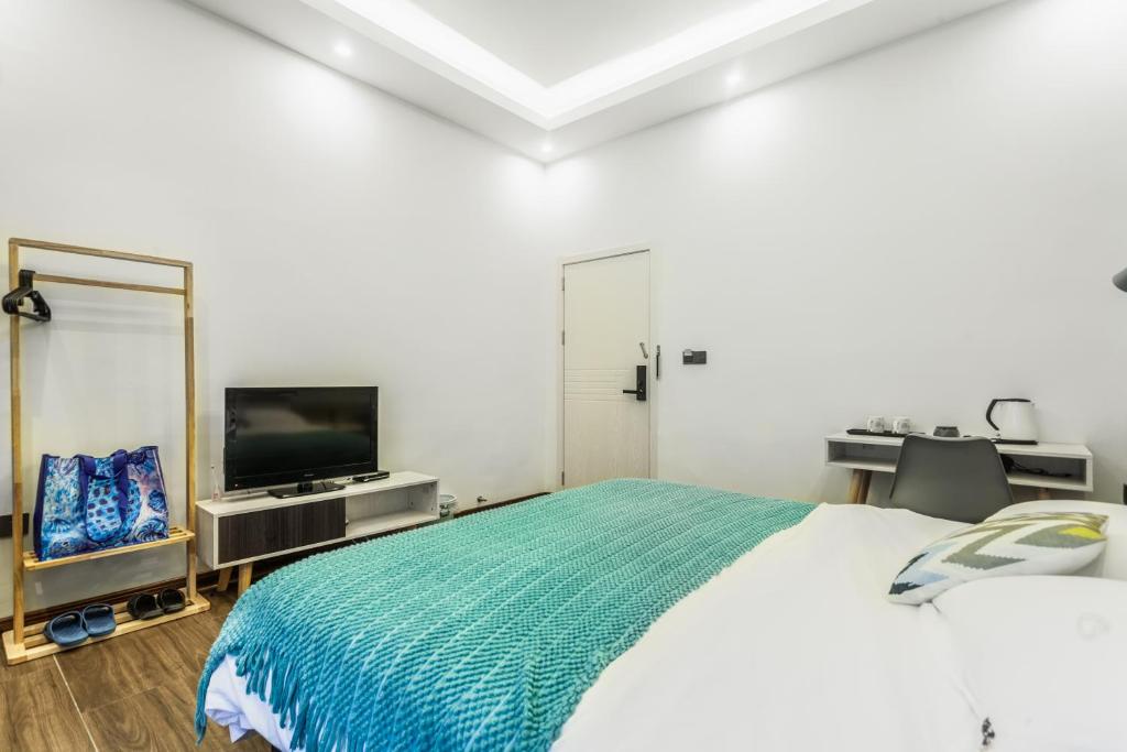 TV a/nebo společenská místnost v ubytování Beihai Silver Beach Yintai Time Seaview Villa Hotel