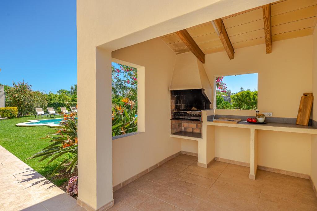 A television and/or entertainment centre at Villa Corb Mari by Sun Villas Mallorca
