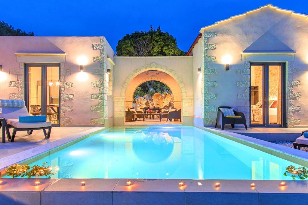 a swimming pool in the middle of a house at Villa Vardis Heated Pool in Vryses