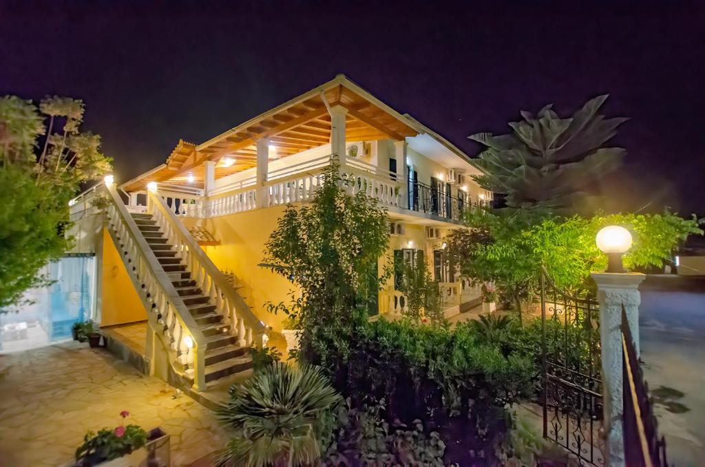 a house with stairs and plants at night at Kapetanios Luxury in Agios Georgios