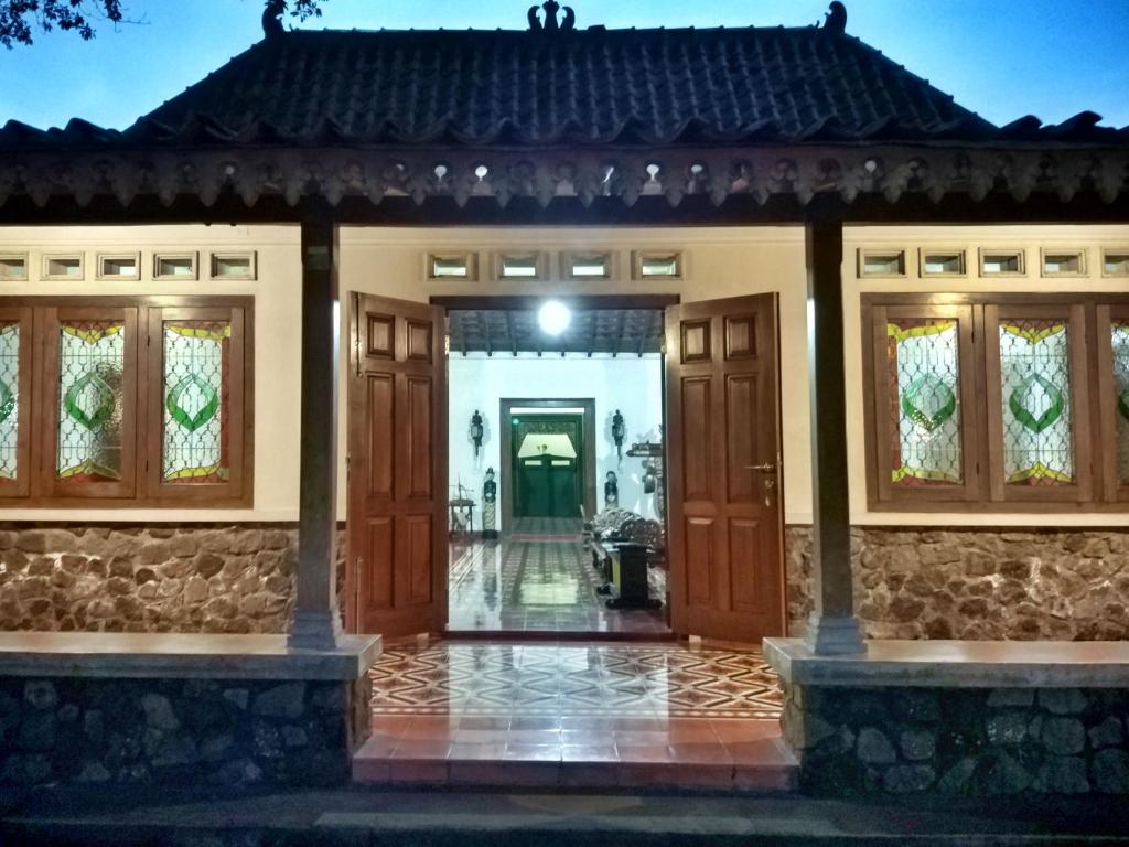 a home with a front door at night at Omah Pitoe Yogya Homestay in Yogyakarta
