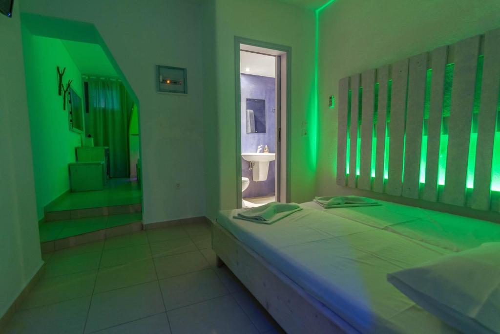 a green room with a bed and a window at Fanari Art in Ios Chora