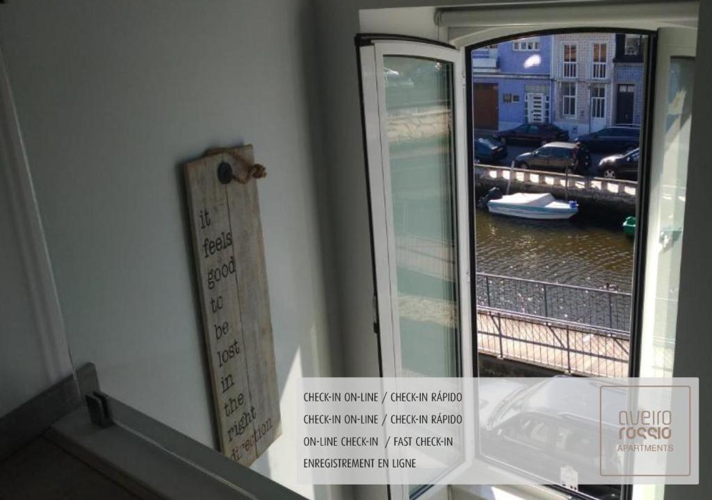 a mirror with a reflection of a view of a river at Aveiro Rossio Apartments in Aveiro