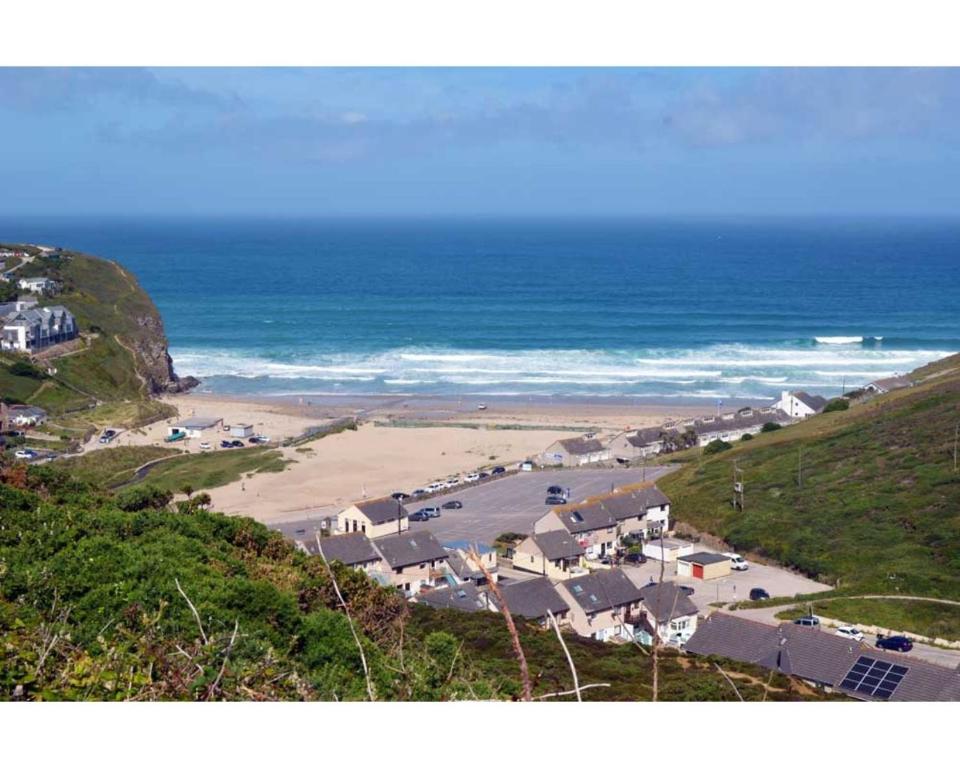 a view of a beach with houses and the ocean at Cornish Holiday - Bodannon in Porthtowan