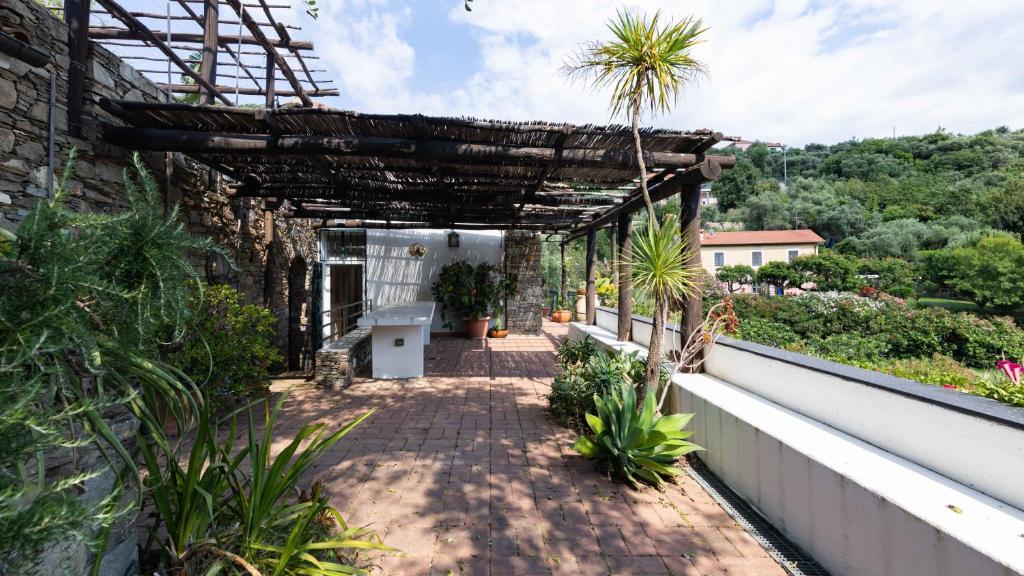 a brick walkway with a pergola on a house at Italianway - Fontanelle 34 in Alassio