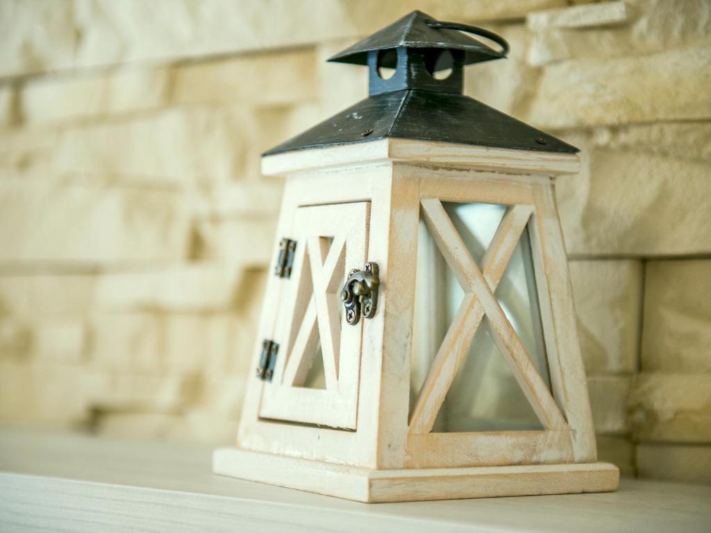 a small wooden lantern sitting on a table at Square Point Apartments in Kotor