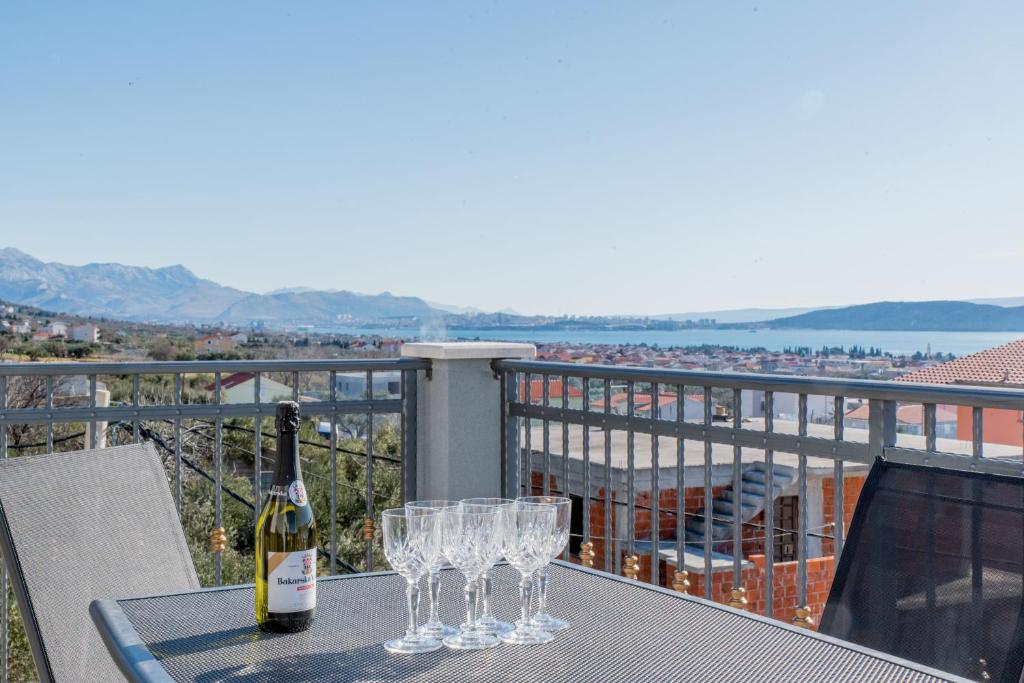 una mesa con dos copas y una botella de vino en Apartments Žilić en Kastel Stari