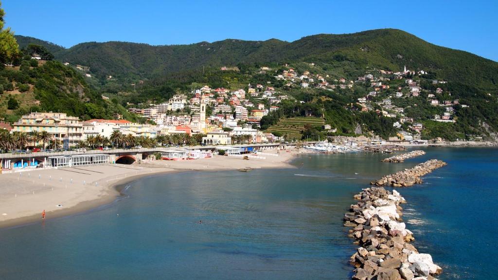 a view of a beach with a town on a mountain at Piccolo Hotel in Moneglia