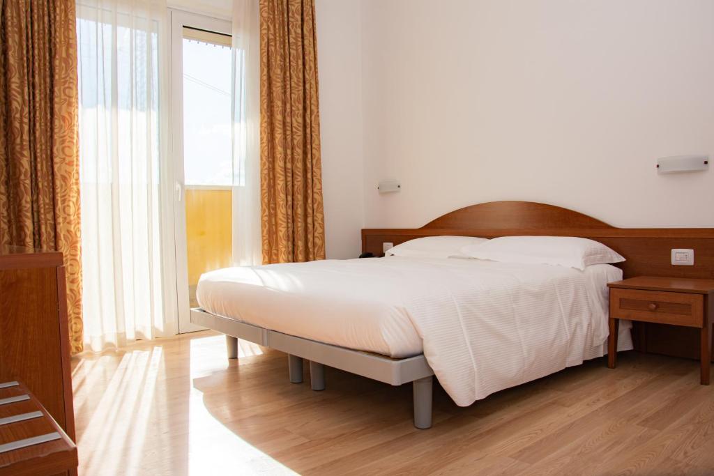 Postel nebo postele na pokoji v ubytování Hotel Nuova Barcaccia