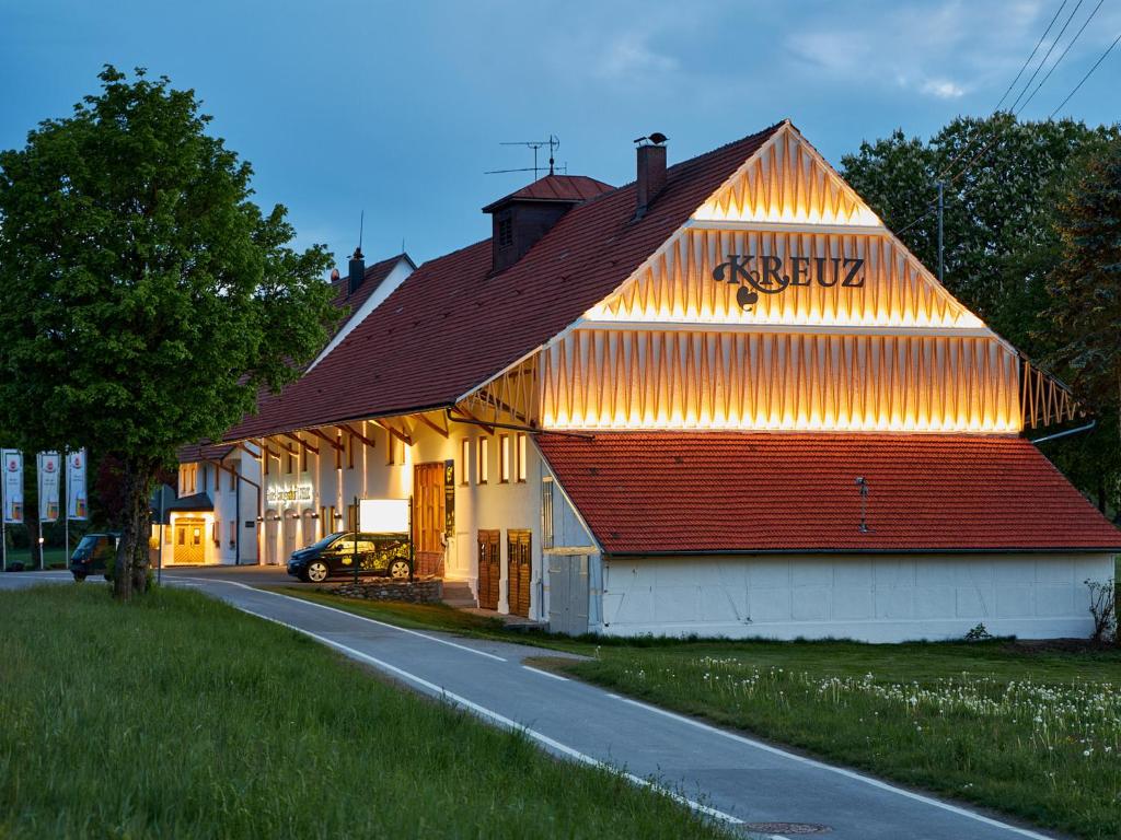 a building with a sign on the side of it at Hotel-Landgasthof KREUZ in Bad Waldsee