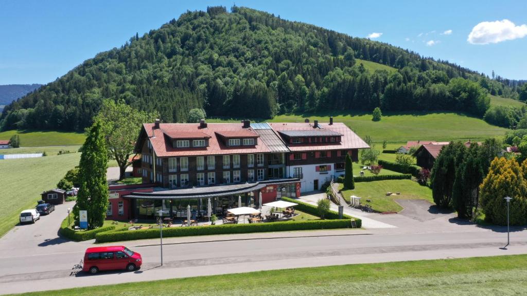 an aerial view of a building with a mountain in the background at Hotel Evviva in Oberstaufen