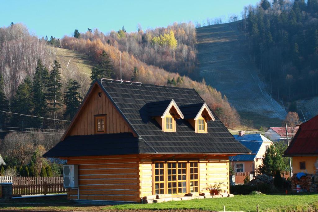 a log cabin with a black roof at Nasa Chata in Levoča