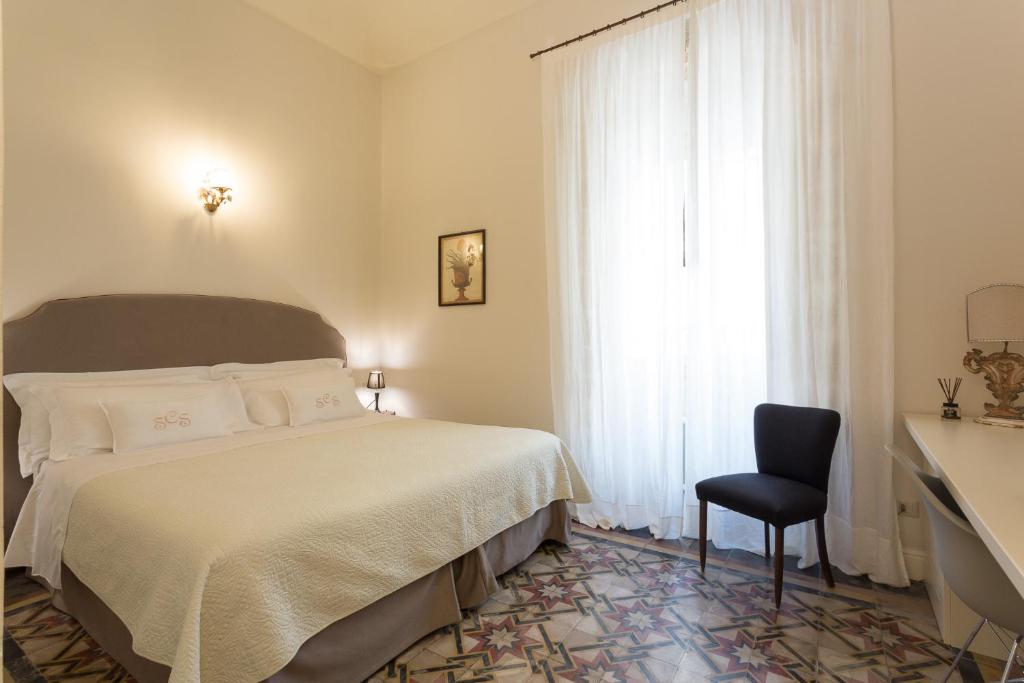 Postel nebo postele na pokoji v ubytování San Carlo Suites