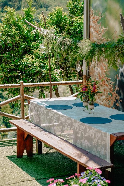a wooden bench sitting next to a table at TEA HOUSE GERÊS in Geres