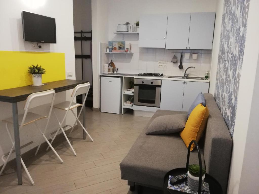 salon z kanapą i kuchnią w obiekcie DIVAS appartamento w mieście Neapol