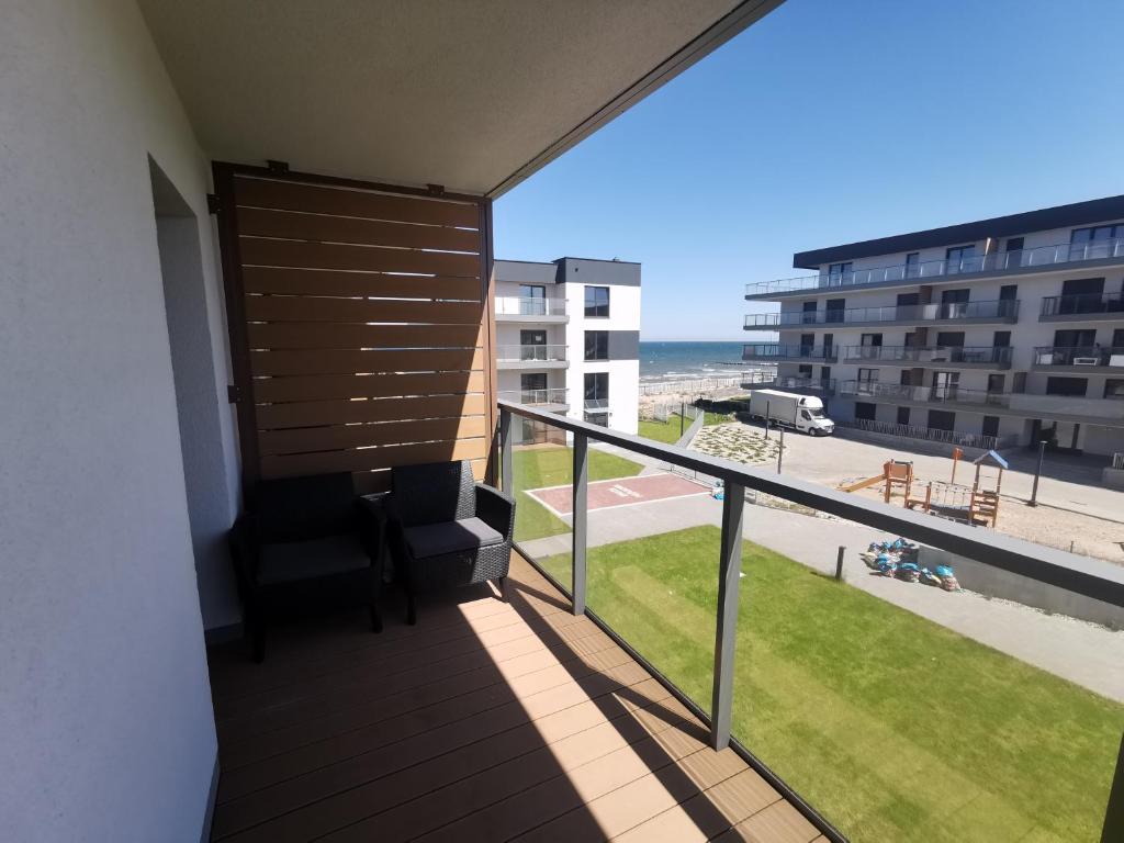 a balcony with a view of the beach at Apartament Gardenia Klif 35 z widokiem na morze in Dziwnów