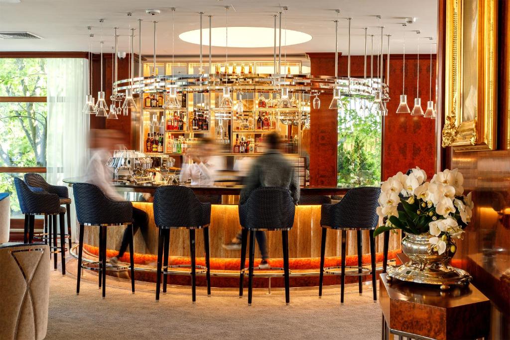 a man sitting at a bar in a restaurant at Haffner Hotel & SPA Sopot - Destigo Hotels in Sopot