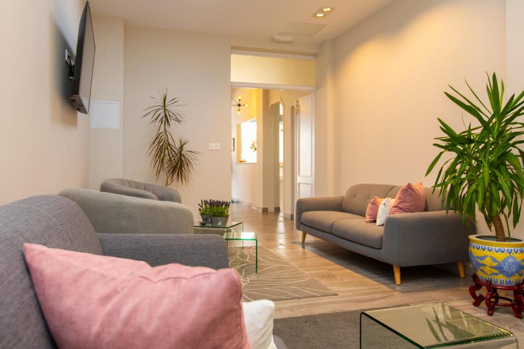 a living room with two couches and a table at Hotel Ros Mary in Ribadeo