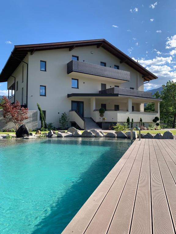 a house with a swimming pool in front of a house at Apartments ANNY in Postal